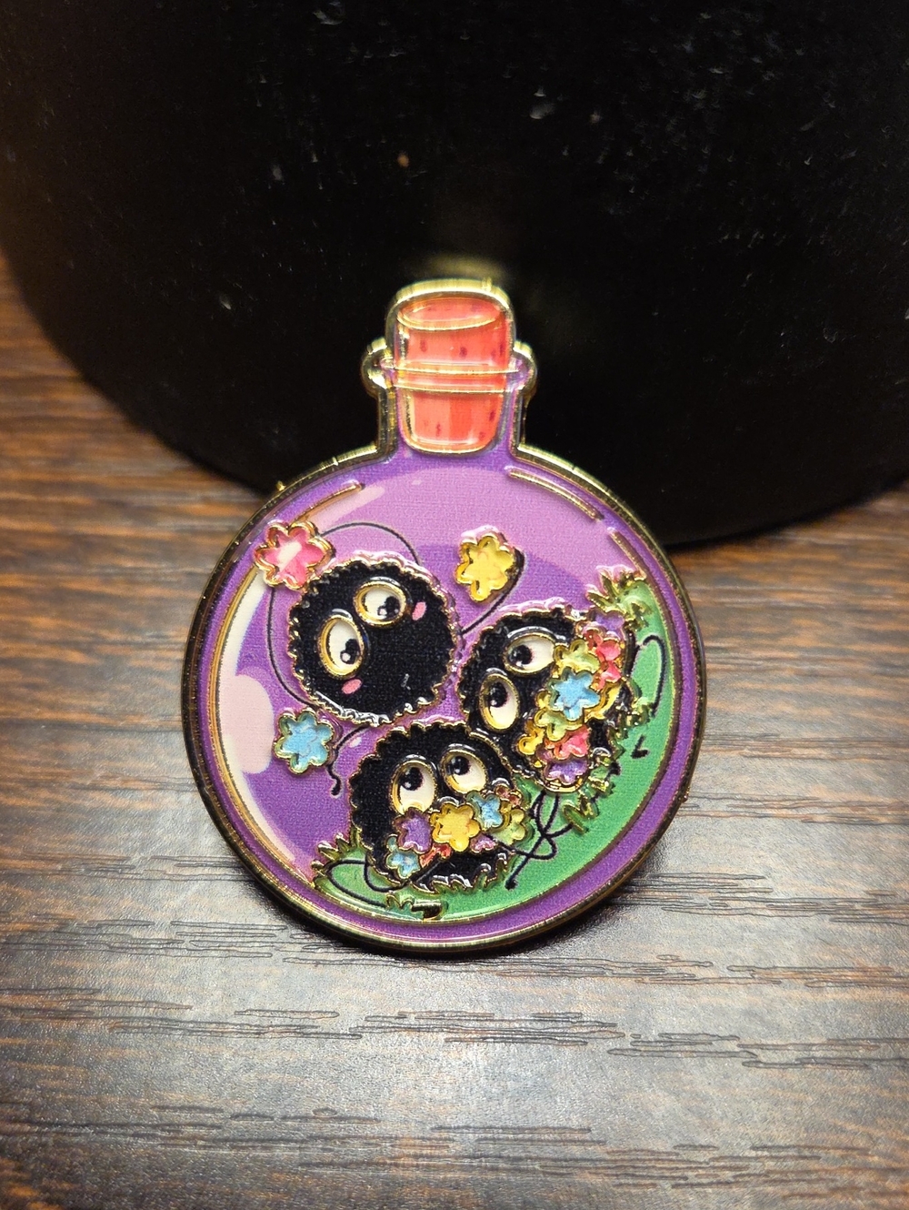Purple Enamel Pin Bottle with Black Soot Sprite Design